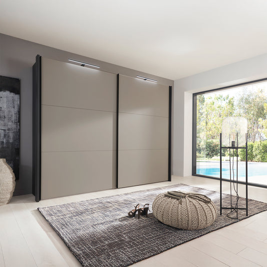 Modern interior with a large Wiemann Glasgow sliding wardrobe in Pebble Grey and Graphite Colour