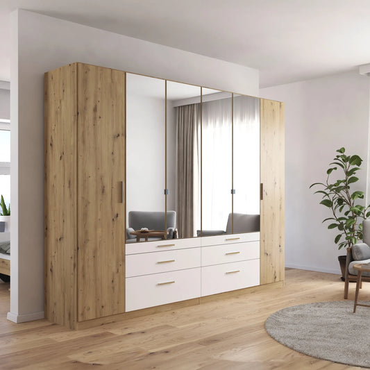 Mosbach 6 Door White & Oak Wardrobe with Mirror and Drawers - 226cm - Side Angle view Styled in a Living Room