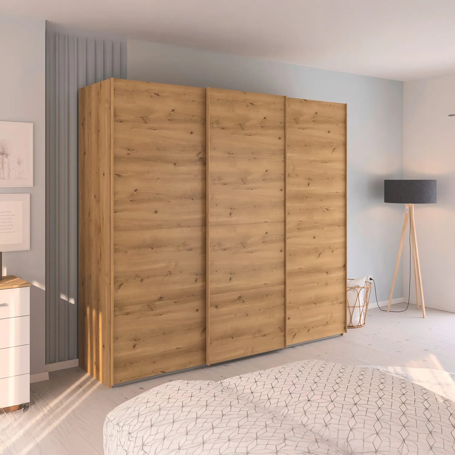 Wooden wardrobe in a bedroom setting with a bed and lamp in the background.