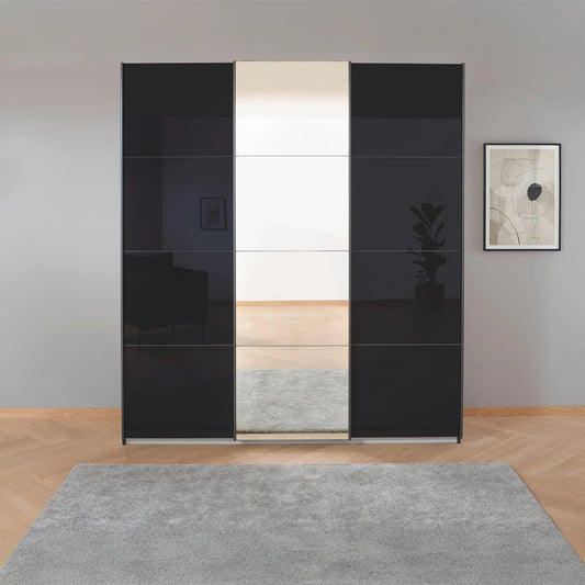 Rauch Forms Black Glass 3 Door Sliding Wardrobe with Mirror - Styled in a Bedroom