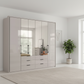 Wiemann Saka 250cm Bi-Fold Wardrobe With 2 Glass Doors & 4 Mirror Doors & 6 Glass Drawers in Glass Pebble Grey styled in a modern room