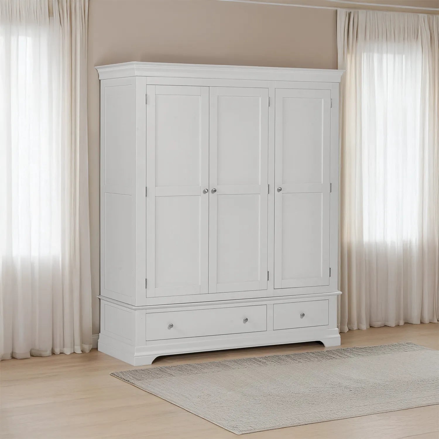 Grey wardrobe with two doors and two drawers in a room with light-colored curtains and wooden floor.