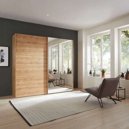 The Corfu Bianco Oak Sliding Wardrobe features mirrored 3-panel doors, smooth-glide rails, adjustable shelves and space-saving style. Choose 200–300cm sizes and mirror side.

