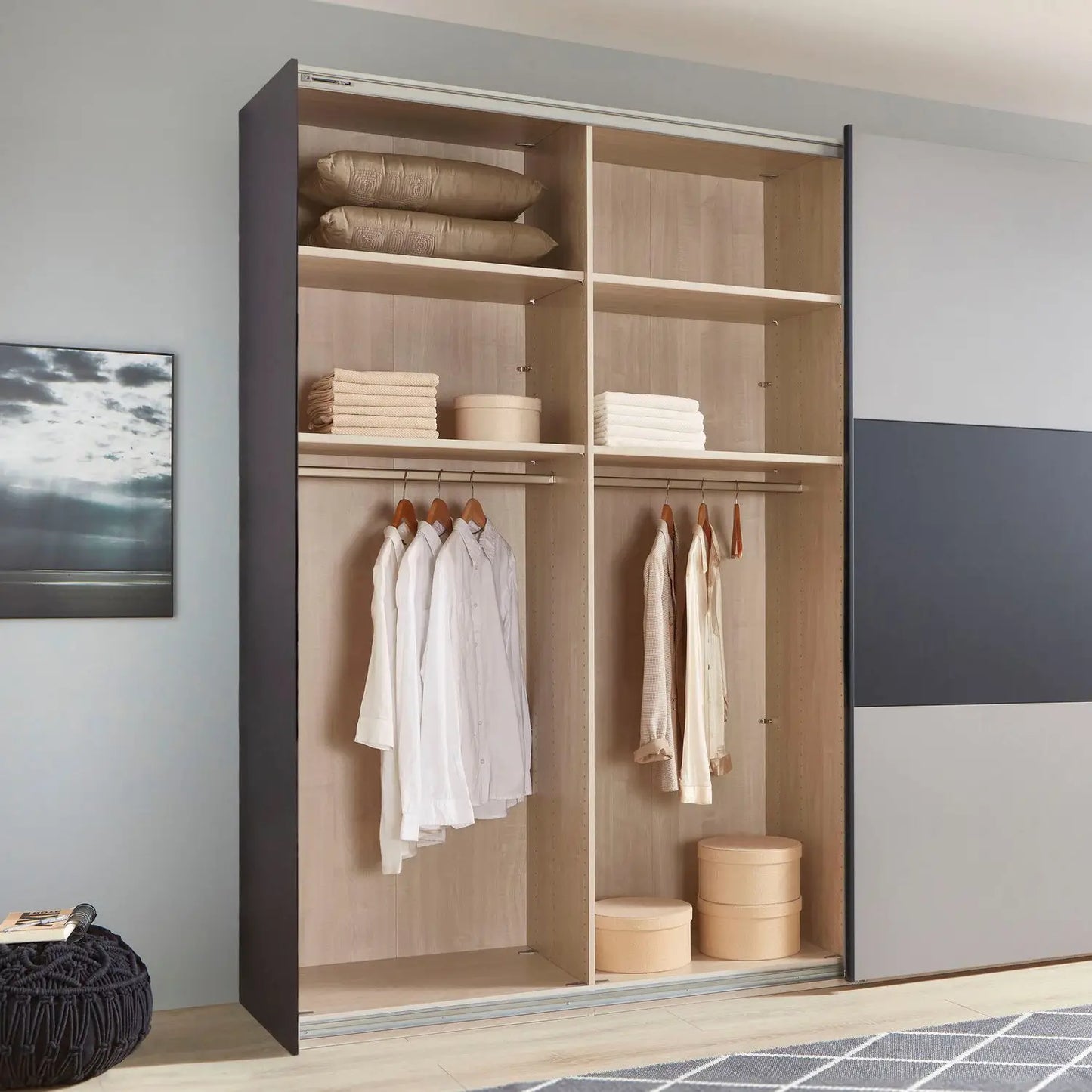 Closet with open doors showing clothes and storage bins, with a neutral color scheme.