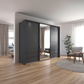 A modern dark gray sliding wardrobe with mirrored doors in a bright, contemporary living room with light wood flooring and neutral decor.