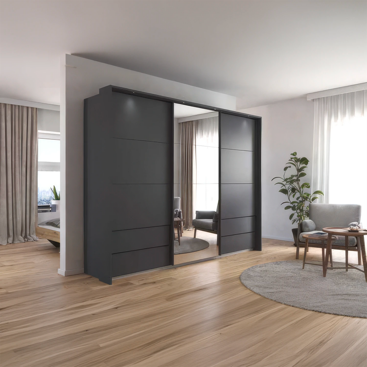 A modern dark gray sliding wardrobe with mirrored doors in a bright, contemporary living room with light wood flooring and neutral decor.