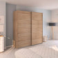 Wooden wardrobe with sliding doors in a bedroom setting