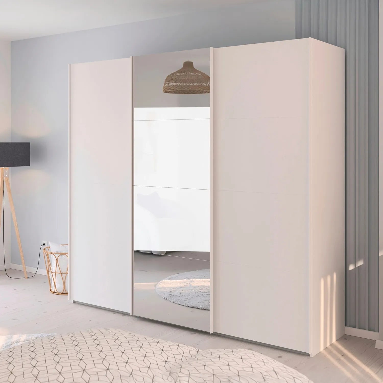 Modern white wardrobe with sliding doors and middle door in mirror in a room setting