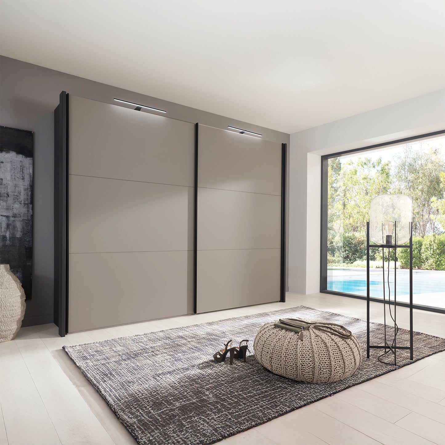 Modern interior with a large Wiemann Glasgow sliding wardrobe in Pebble Grey and Graphite Colour