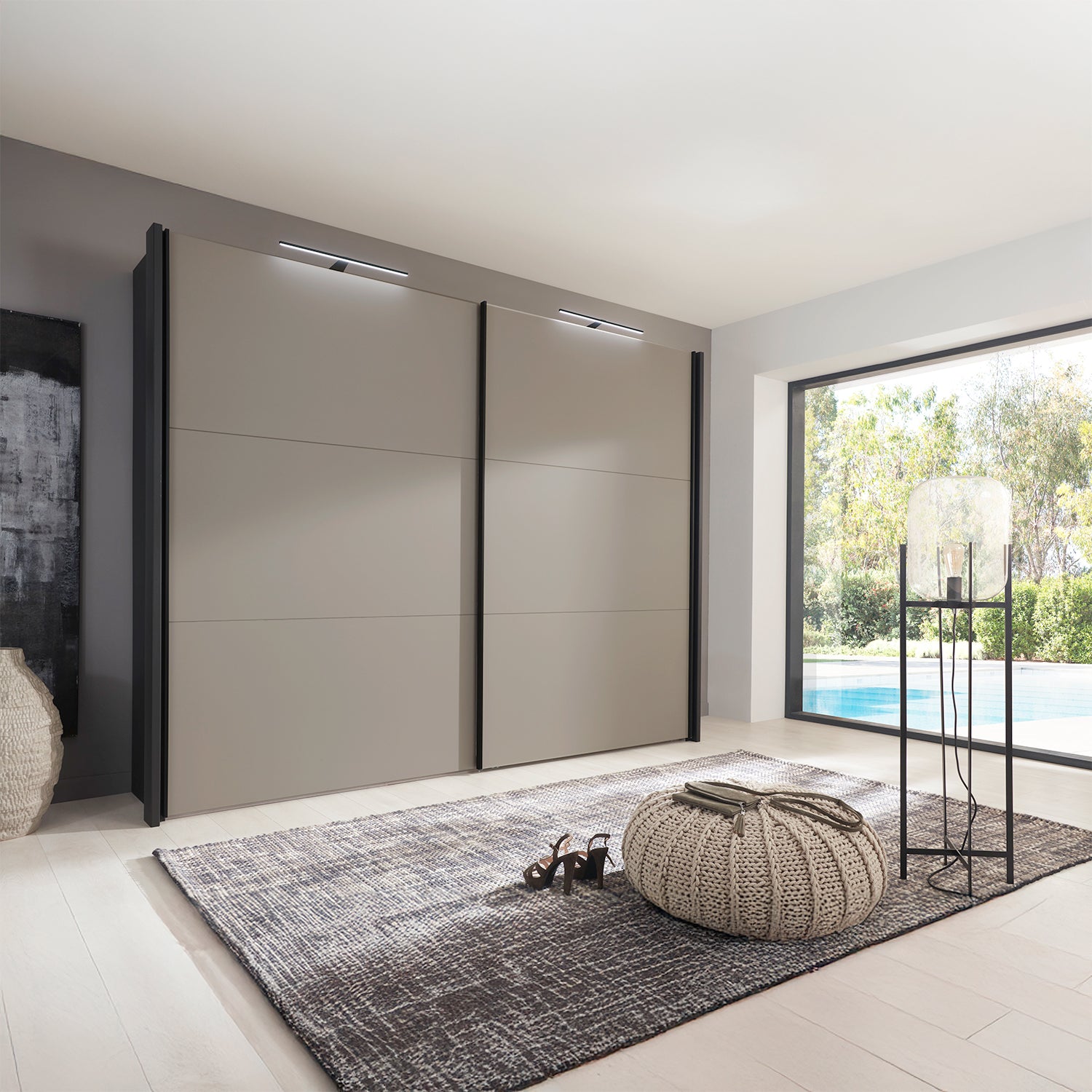 Modern interior with a large Wiemann Glasgow sliding wardrobe in Pebble Grey and Graphite Colour