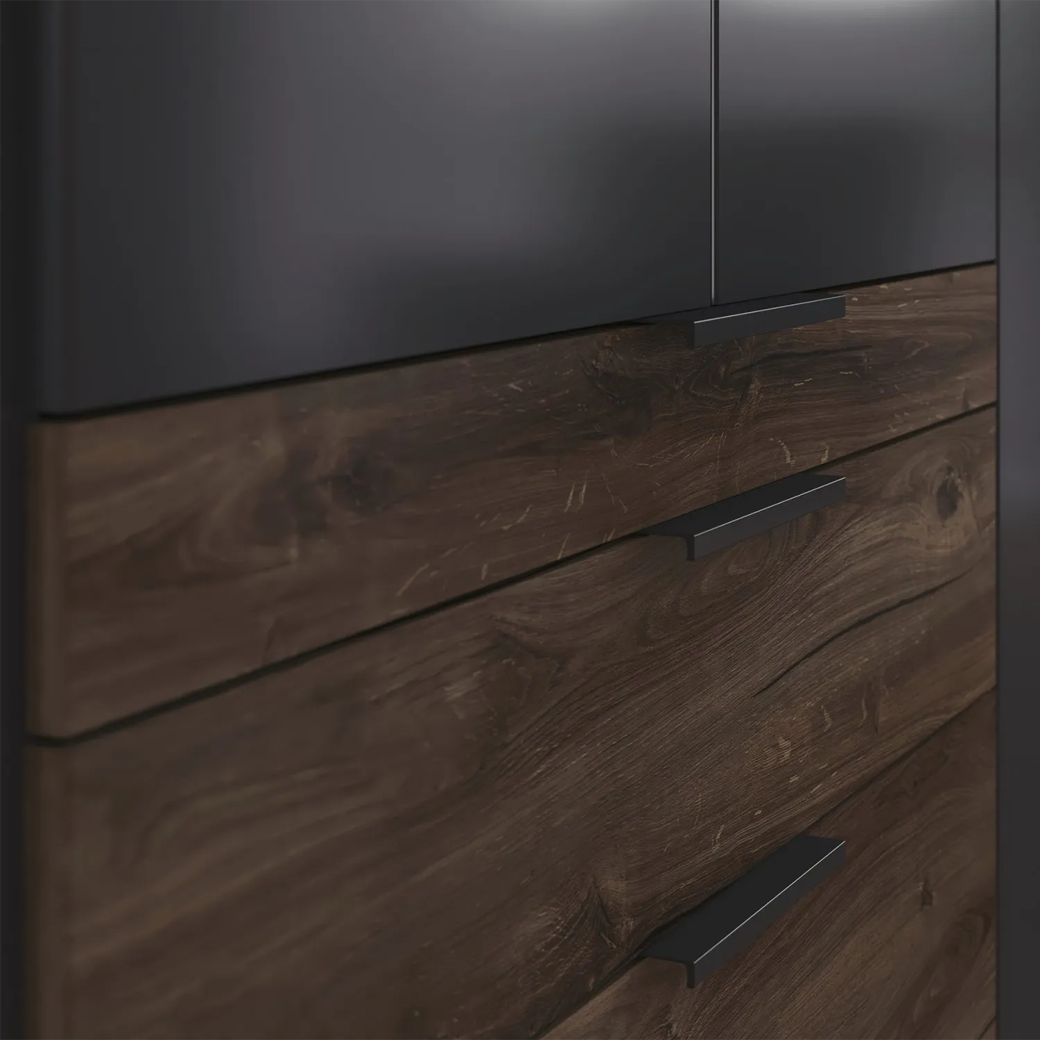 Close-up of a wooden dresser with dark brown finish and black handles.