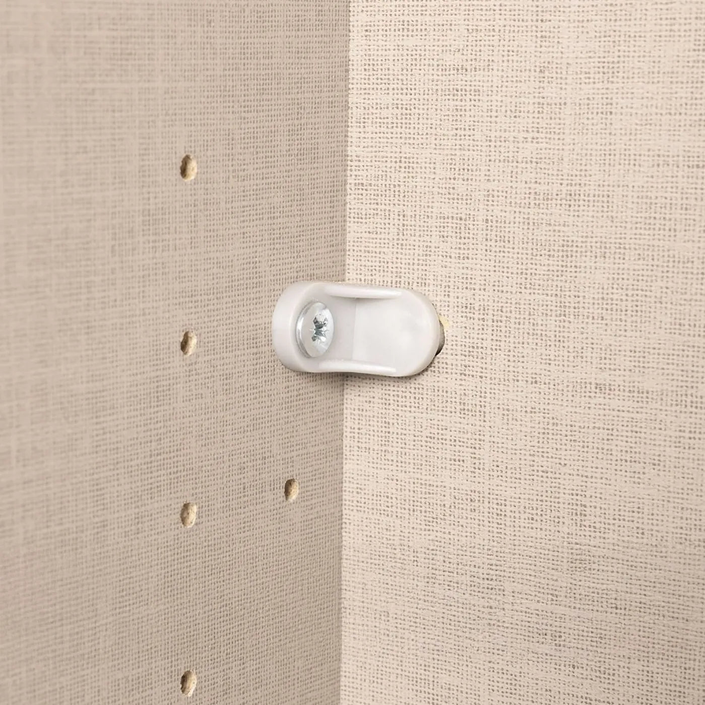 Close-up of a plastic bracket on a wardrobe backing