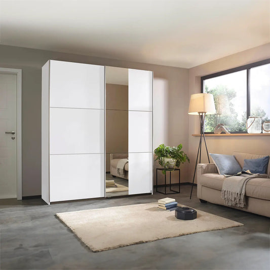 Modern bedroom with a large white wardrobe, beige sofa, and decorative items.