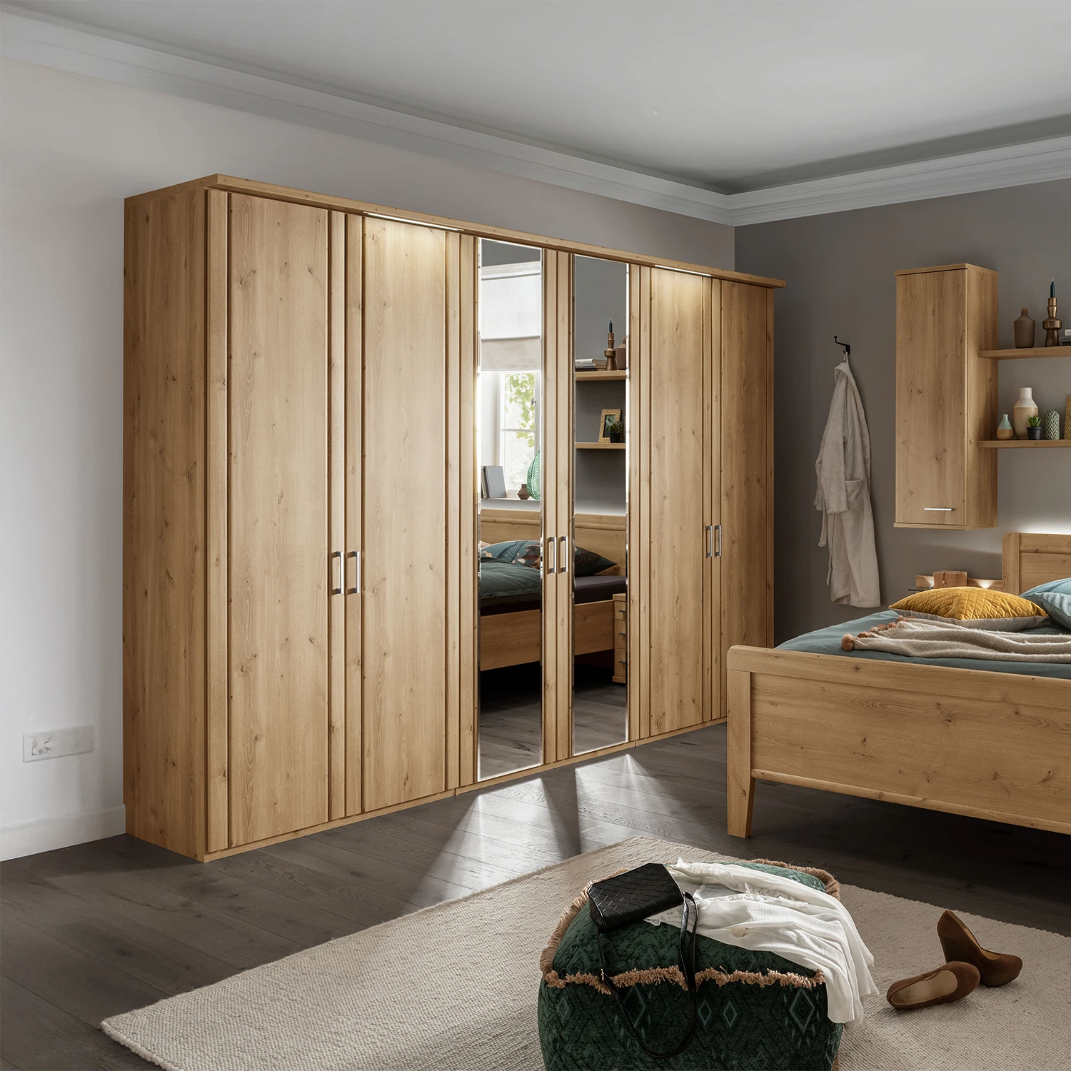 Wooden wardrobe with mirrored doors in a bedroom setting