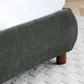 Close up of the wooden legs on the Mallow Olive Boucle Fabric Upholstered Bed 