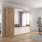 Mosbach 6 Door White & Oak Wardrobe with Mirror and Drawers - 226cm - Side Angle view Styled in a Living Room