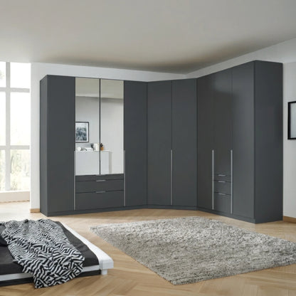 A large modular Corner wardrobe system in dark Metallic grey , featuring mirrored doors, drawers, and cabinet doors with slim silver handles, installed in a modern bedroom corner.
