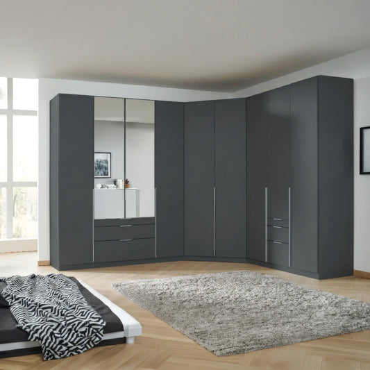 A large modular Corner wardrobe system in dark Metallic grey , featuring mirrored doors, drawers, and cabinet doors with slim silver handles, installed in a modern bedroom corner.