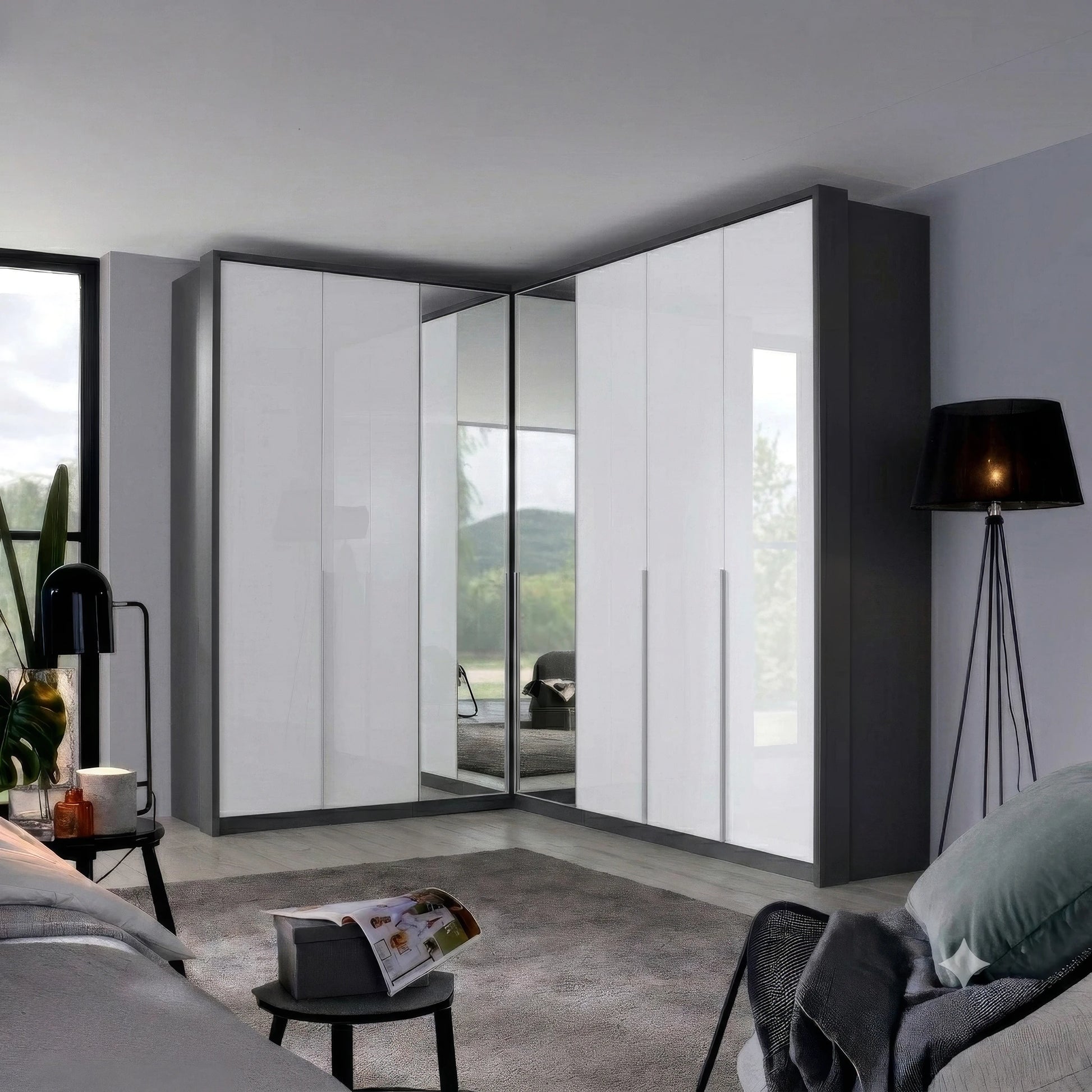 A modern Rauch Alabama corner wardrobe with white high-gloss doors and dark gray side panels, including mirrored doors that reflect the room. The wardrobe is installed in a contemporary bedroom setting with a bed, side tables, and a floor lamp.