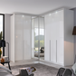 A modern Rauch white high-gloss Hinged door corner wardrobe system with Middle mirror doors and LED light Passepartout Frame