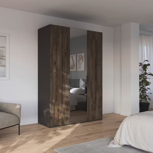 A modern Rauch Atlantic Wardrobe wardrobe with two dark brown wood-grain doors and mirrored sliding panels, set in a bright, contemporary bedroom.