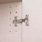 Close-up of a silver metal wardrobe hinge mounted on a Atlantic Oak 3 Door wardrobe