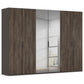 Tall  modern Rauch Fifty Atlantic Oak six door wardrobe with four dark brown wood grain doors and two mirrored doors, shown against a plain white background.