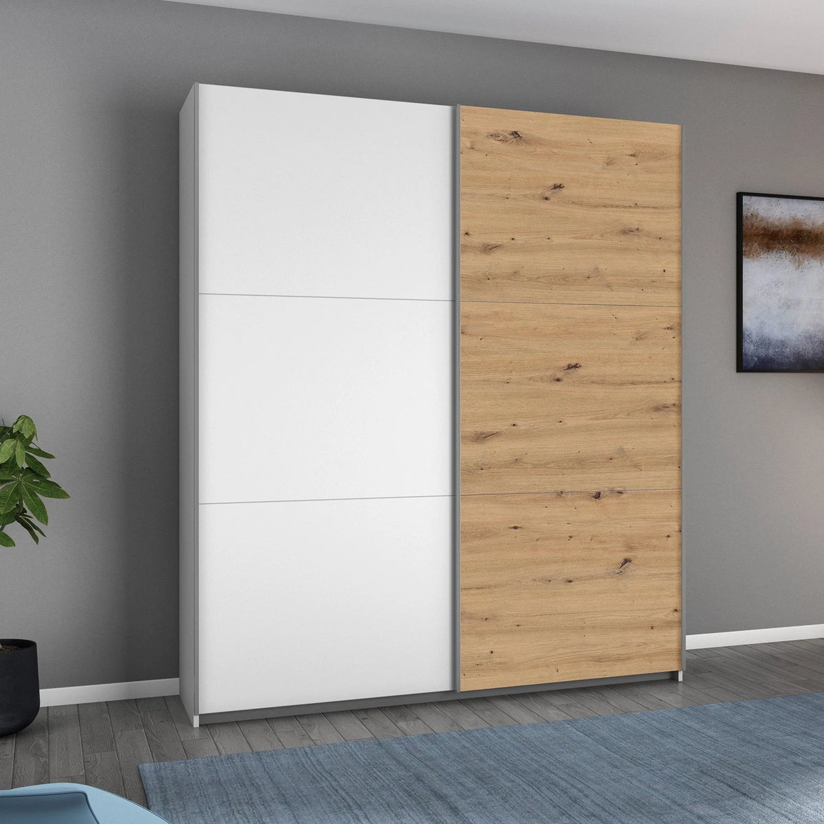 Rauch Aurelia White & Artisan Oak Sliding Door Wardrobe styled in a modern bedroom