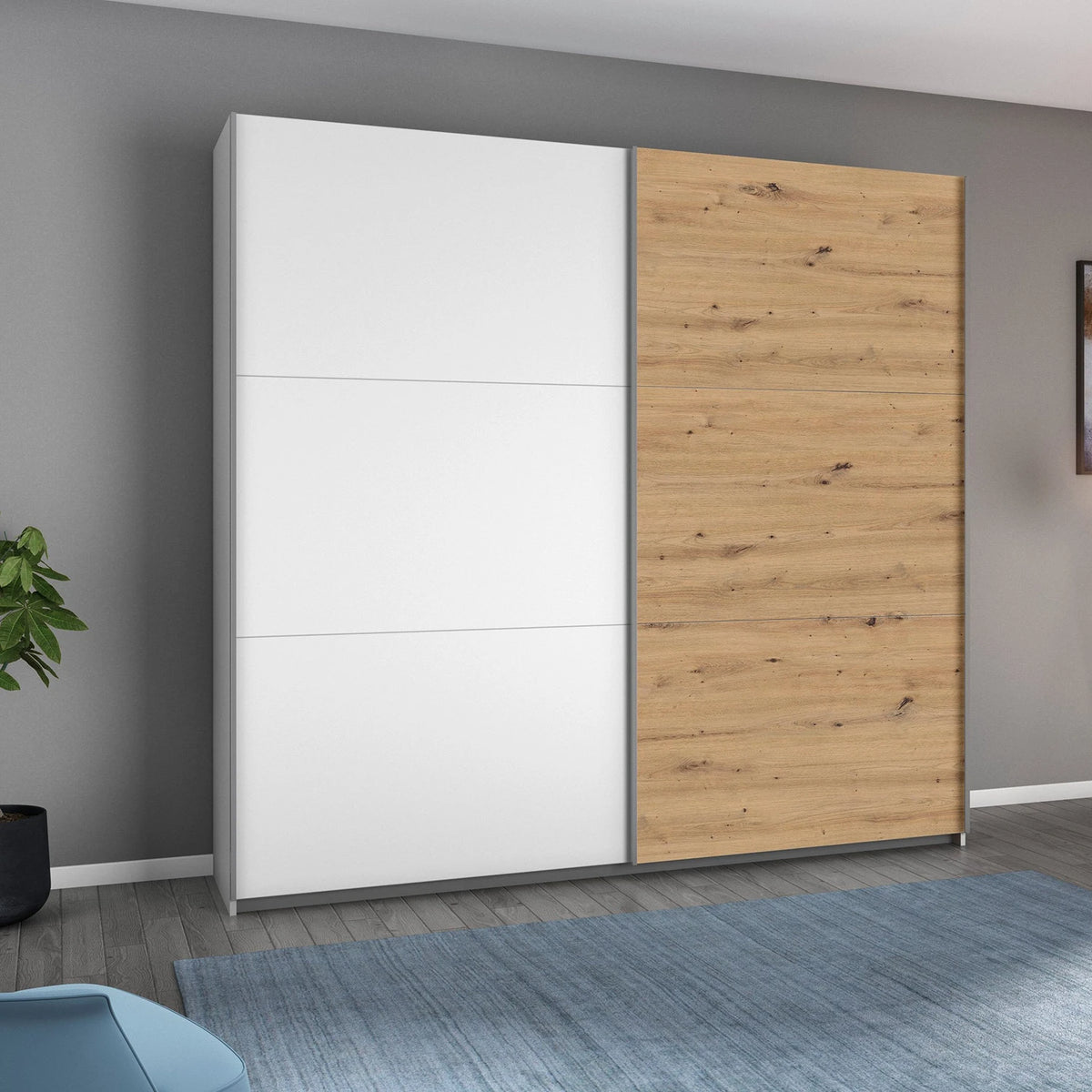Rauch Aurelia White & Artisan Oak Sliding Door Wardrobe styled in a beautiful room