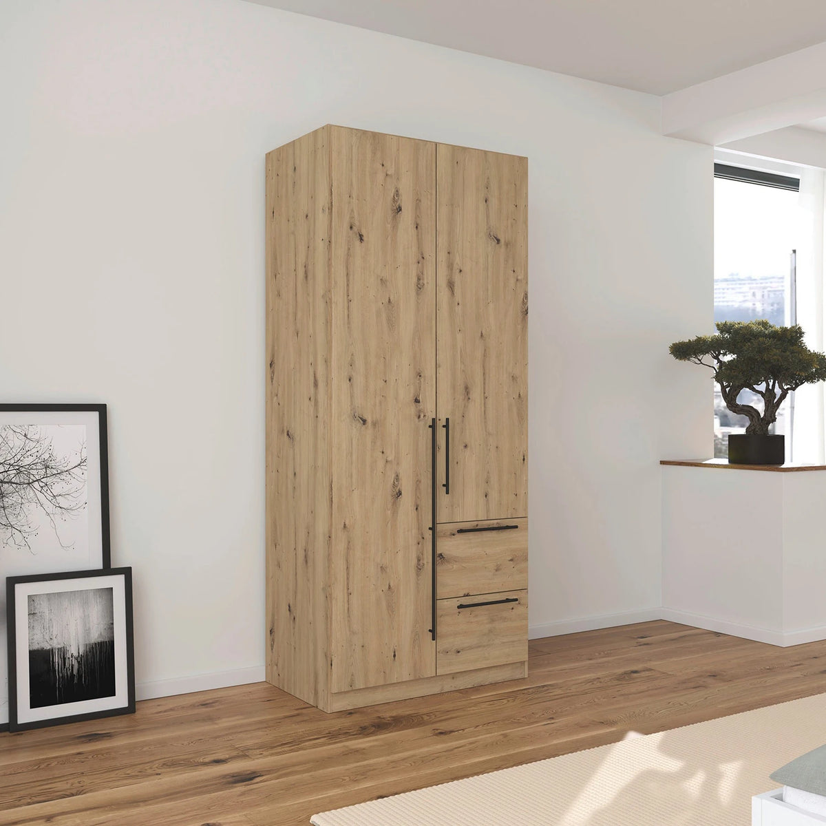 Rauch Avola 2 Door, 2 Drawers Combi Wardrobe 91cm in Oak styled in a bedroom