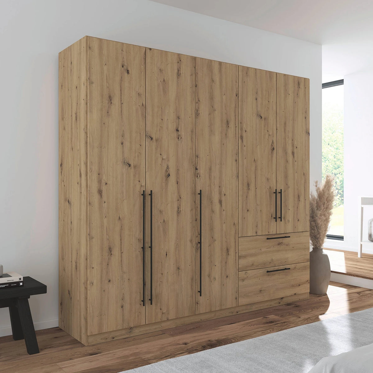 Rauch Avola 5 Door, 2 Drawers Combi Wardrobe 226cm in Oak styled in a modern bedroom