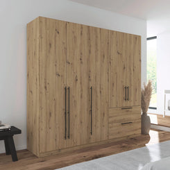 Rauch Avola 5 Door, 2 Drawers Combi Wardrobe 226cm in Oak styled in a modern bedroom