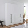 Rauch Avola 5 Door, 2 Drawers Combi Wardrobe 226cm in Alpine White styled in a modern bedroom