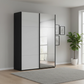 A modern Rauch Contido wardrobe with two sliding doors, one Silk Grey Glass and one mirrored, and Has Matching Black Door Handle Bars set in a minimalist room with a gray rug, potted plant, and light wood flooring.