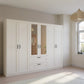 Rauch Cottage 271cm Wide 6 Door Wardrobe with Drawers & Mirror - Styled in a Bedroom