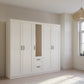 Rauch Cottage 226cm Wide 5 Door Wardrobe with Drawers & Mirror - Styled in a Bedroom