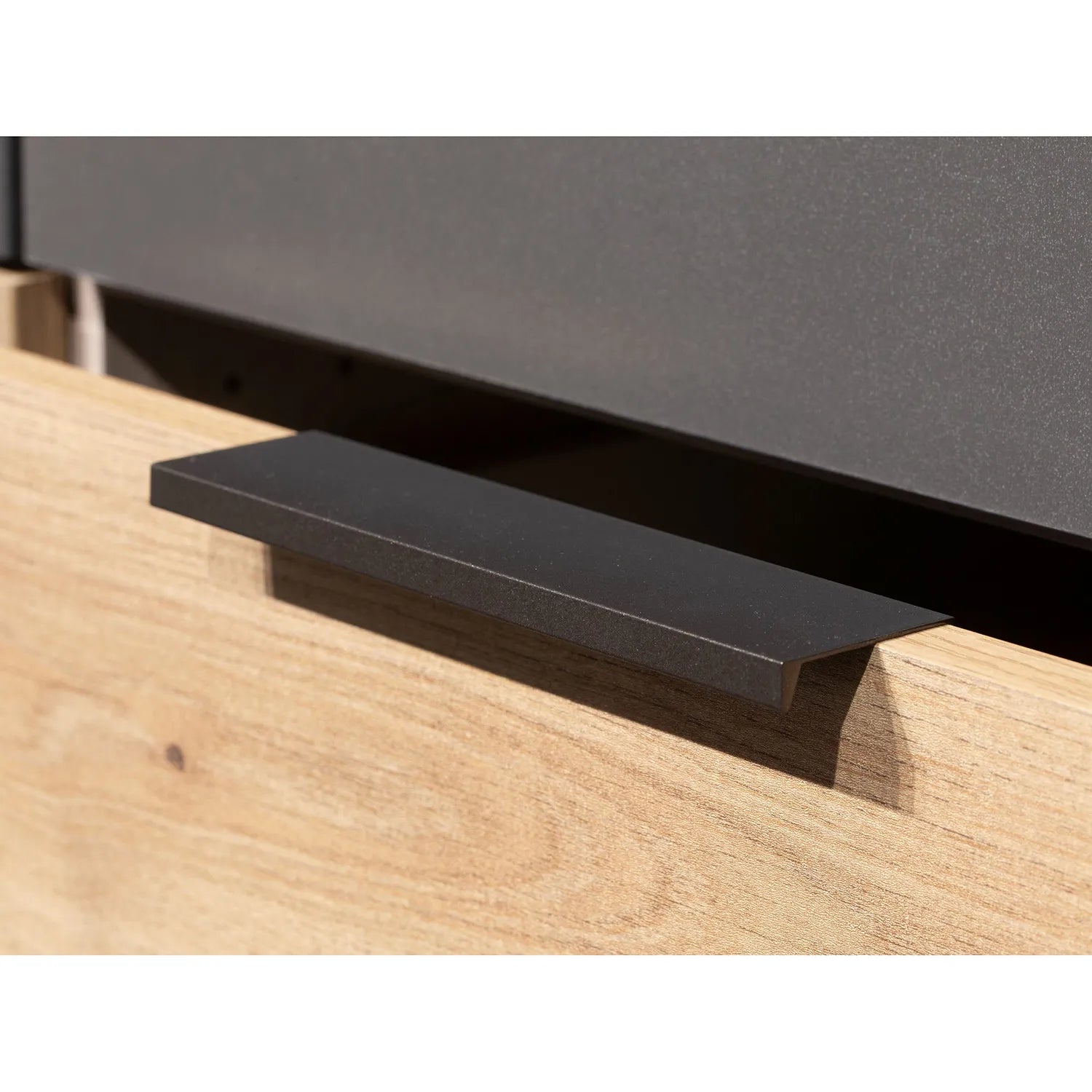Black metal handle on a Rauch Davo 4 door wardrobe with mirror doors and Artisan Oak drawers