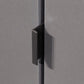 Close-up of a black cabinet handle on a gray cabinet door