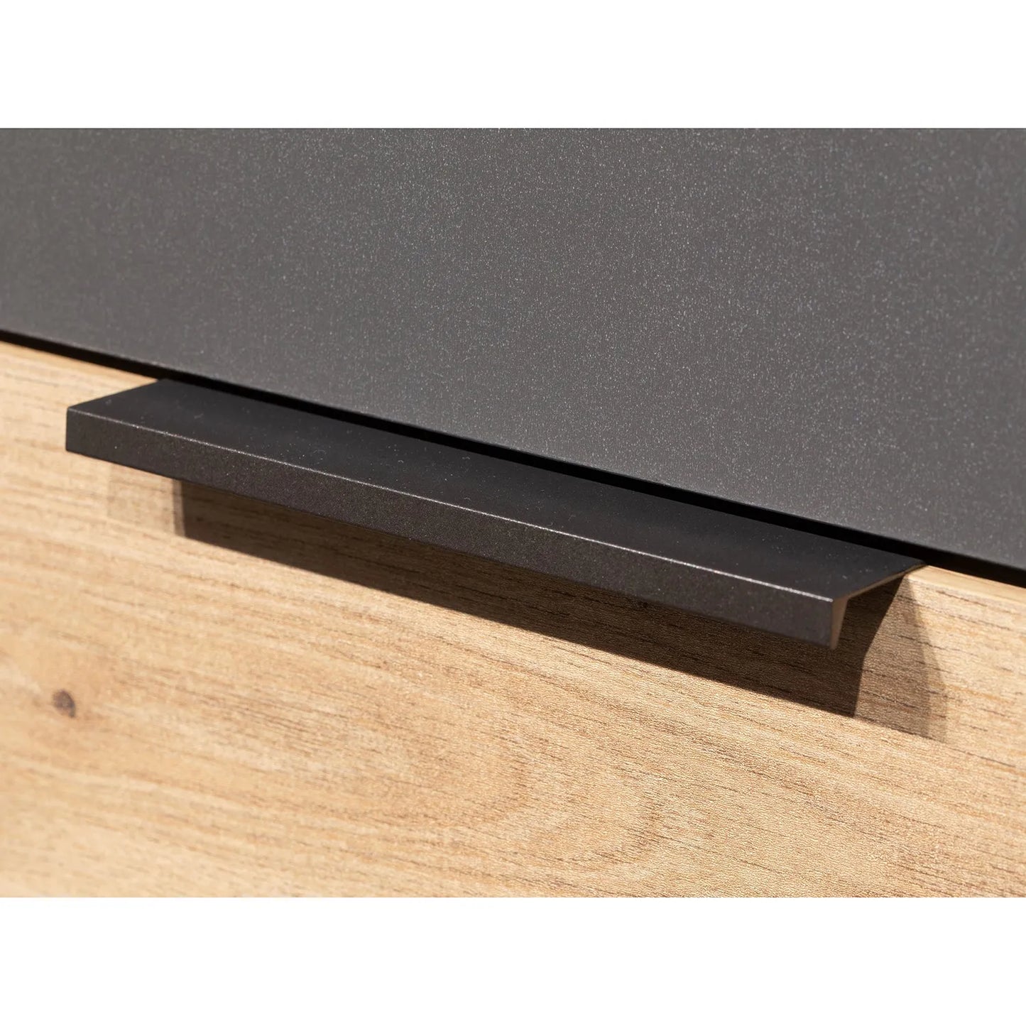 Close-up of a black handle on a wooden drawer of Rauch Davo 4 door wardrobe with mirror doors and Artisan Oak drawers