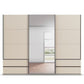 A modern Rauch Elara Large 271cm wide Doors Champagne Sliding Door Wardrobe with Drawers under side doors and Middle Mirror Door