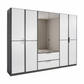 A modern Rauch Essensa  six-door wardrobe with a white glossy finish and dark gray frames, featuring two central mirrored doors showing an empty closet space, two lower drawers with silver handles, and two side doors with dark handles, set against a plain white background.