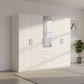 A modern Rauch white wardrobe with five doors, including one door with vertical mirror  and a central section with three drawers.