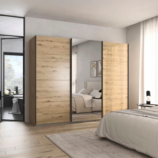 Rauch Forms three door sliding wardrobe in Artisan Oak with a mirrored centre door and graphite bar handles

