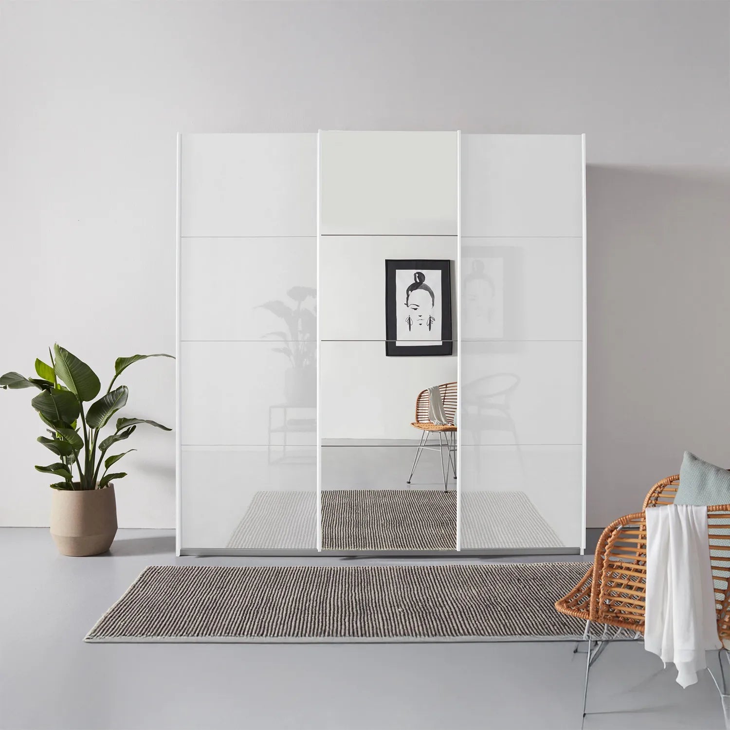 Rauch Forms White High Gloss 3 Door Sliding Wardrobe with Mirror - Styled in a Bedroom