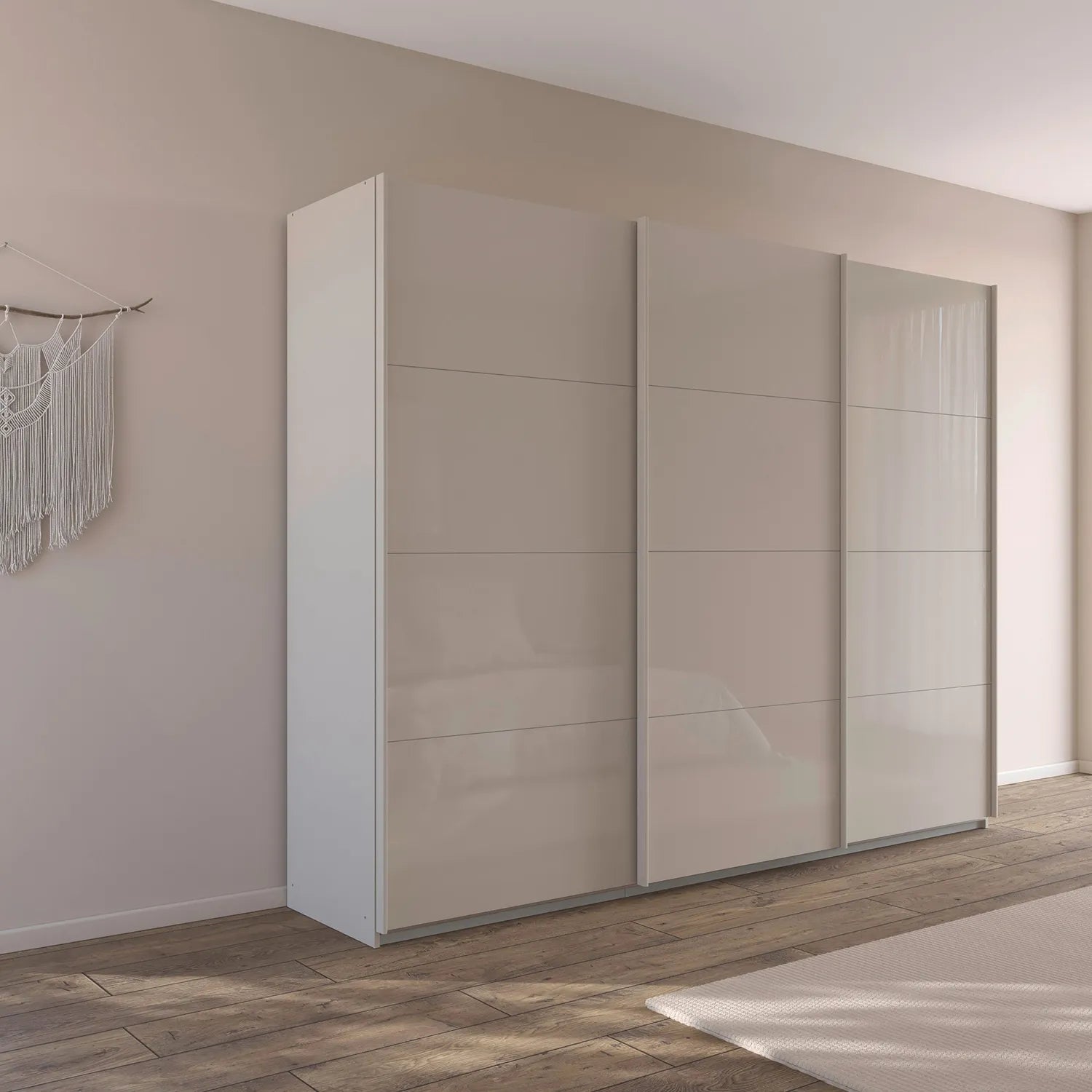 A modern three-door sliding wardrobe with glossy light beige doors, Rauch Kulmbach Formes shown in a minimalist bedroom setting with a wood floor and neutral wall.
