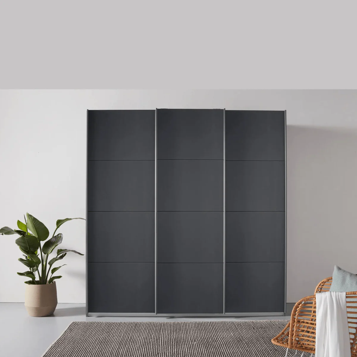 Rauch Forms Metallic Grey Decor 3 Door Sliding Wardrobe - Styled in a Bedroom