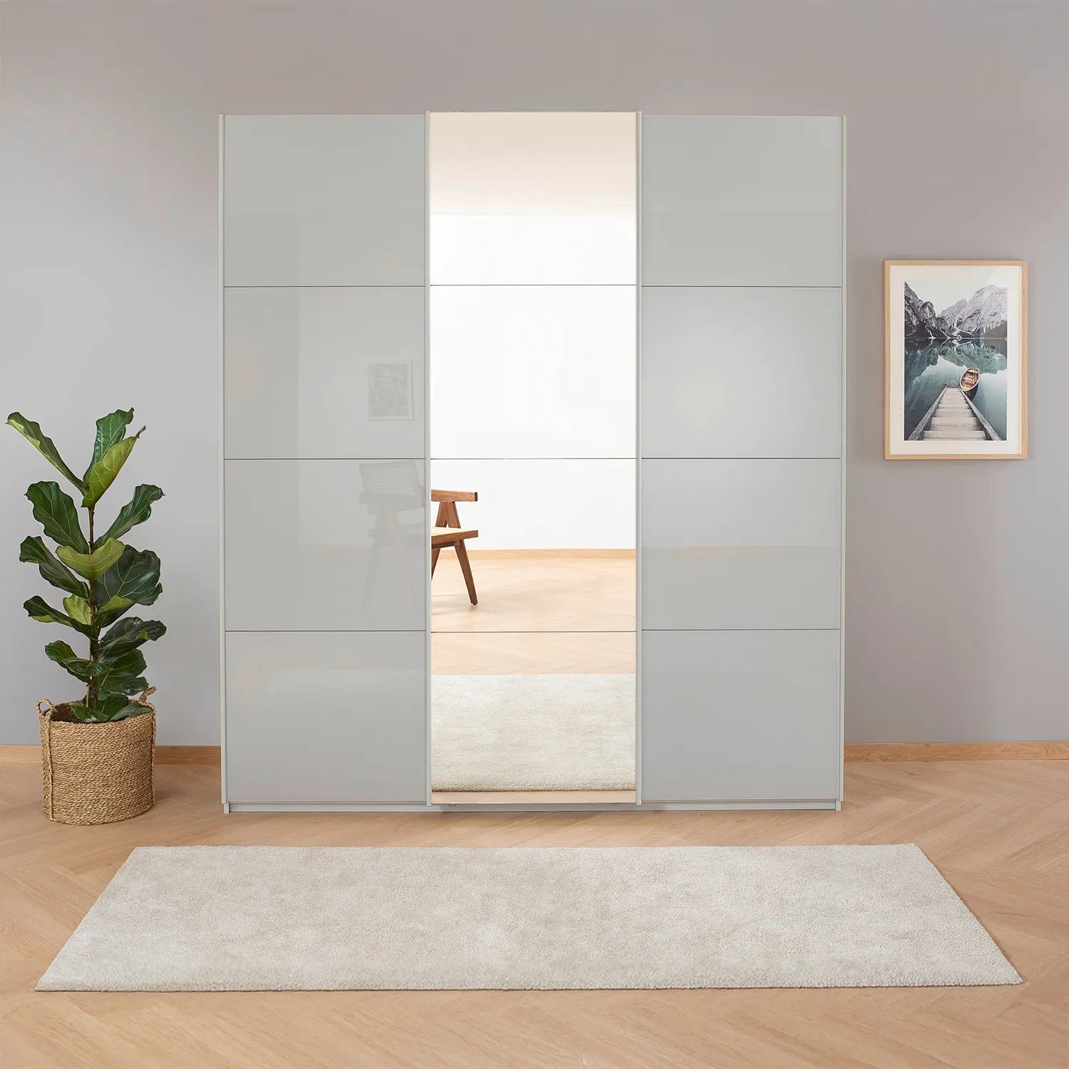 Rauch Forms Silk Grey Glass 3 Door Sliding Wardrobe with Mirror - Styled in a Living Area
