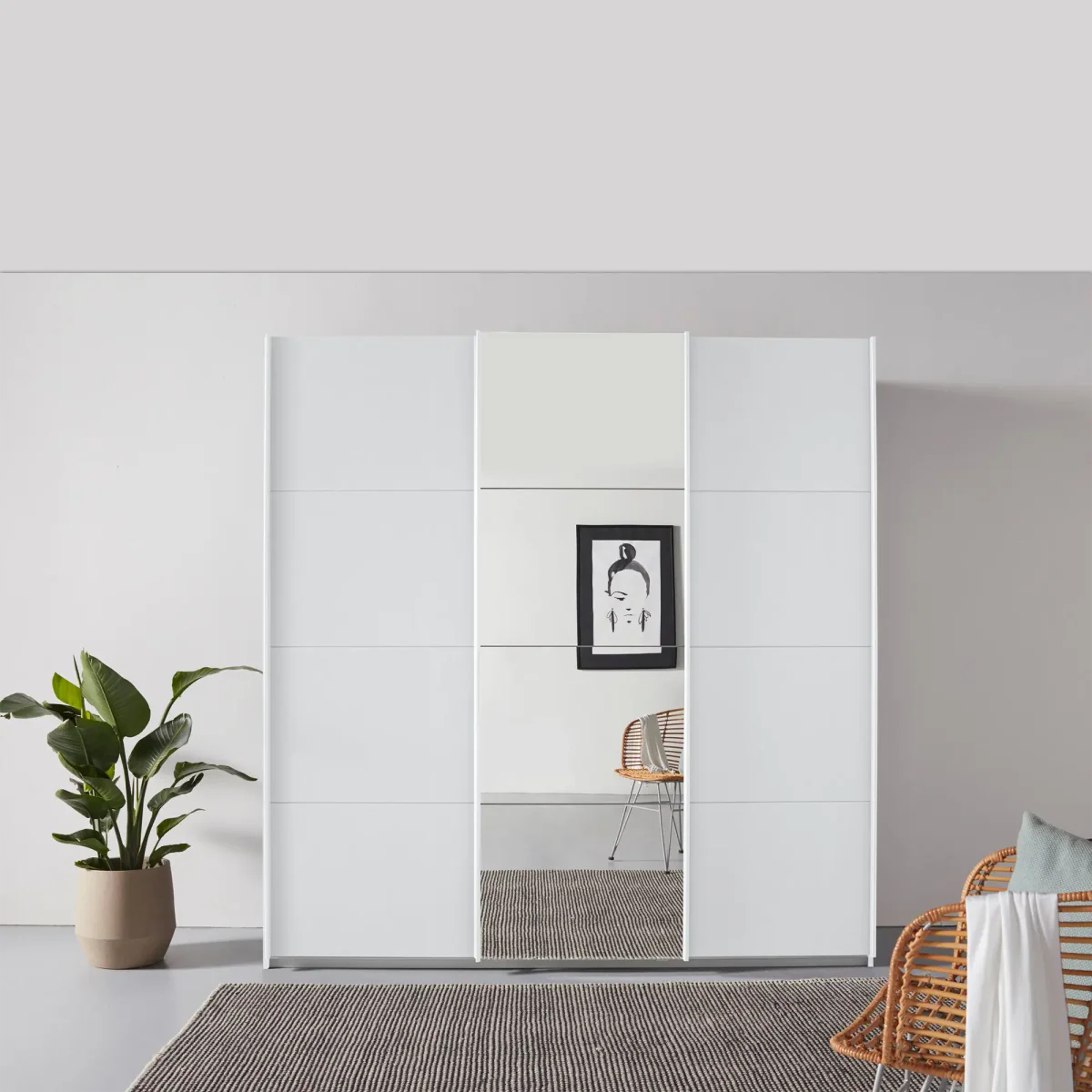 Rauch Forms White Decor 3 Door Sliding Wardrobe with Mirror - Styled in a Bedroom
