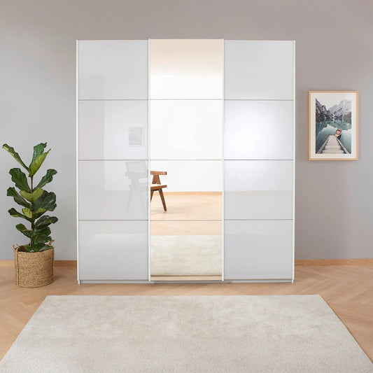 Rauch Forms White Glass 3 Door Sliding Wardrobe with Mirror - Styled in a Bedroom
