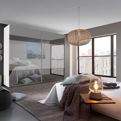 Rauch Frankfurt Two Tone Mirror Front Sliding Door Wardrobe - W316cm - Styled in a Bedroom